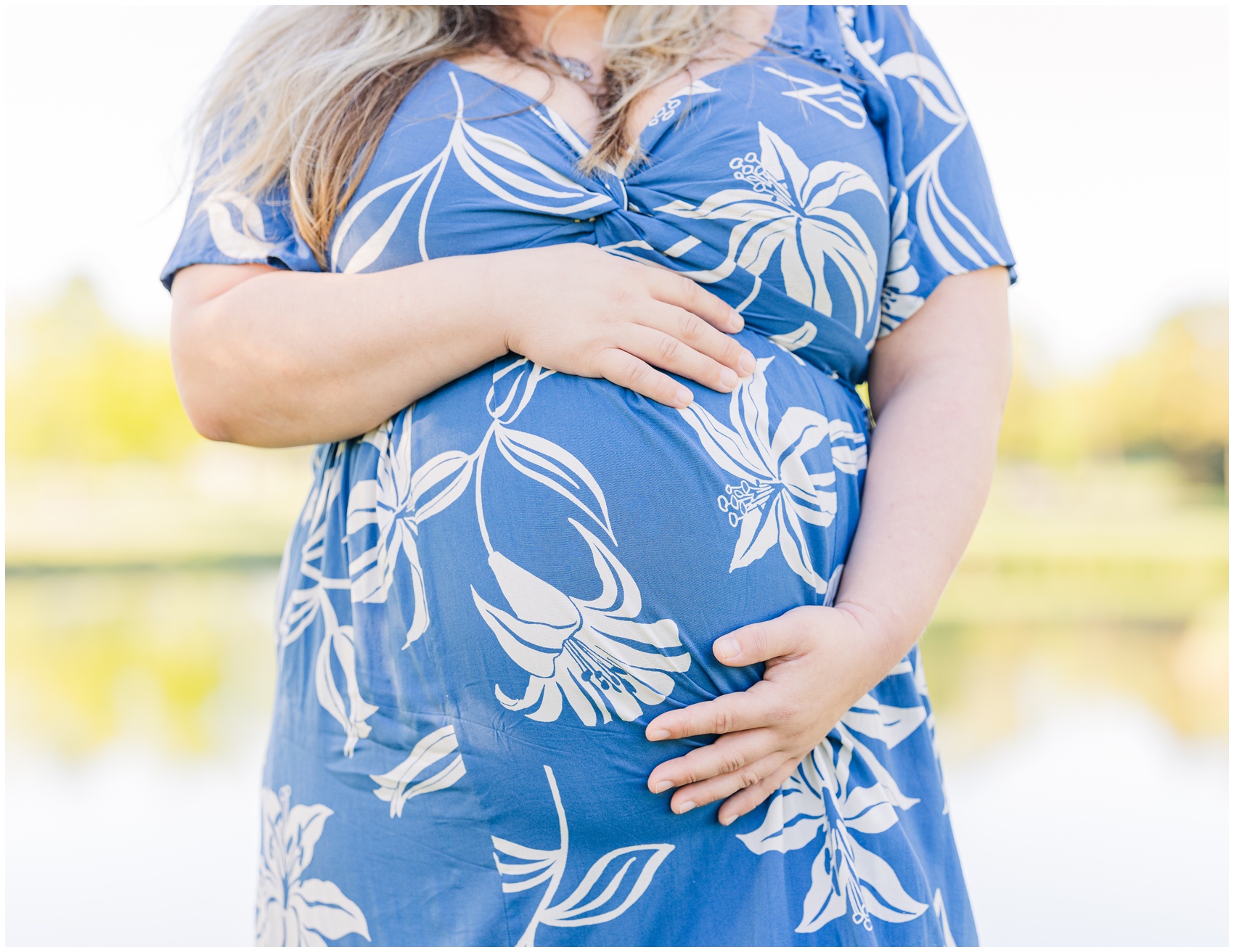 Details of a mother to be's bump with her hands on it after some prenatal yoga in ann arbor